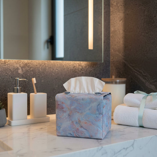 Handmade fabric tissue box covers with pastel abstract design displayed in a hallway and living room