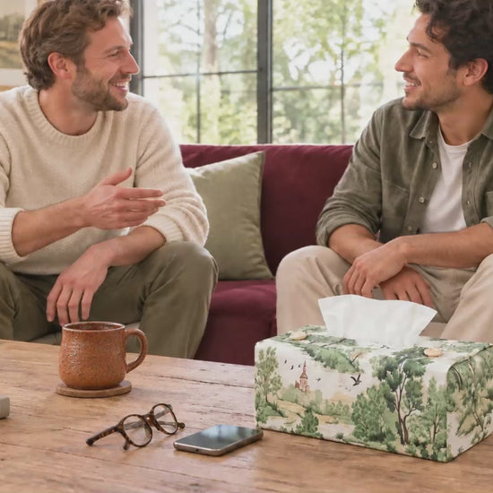 Handmade rectangular cotton tissue box cover with traditional country toile pattern in green on an off-white background, displayed in living room and bedroom.