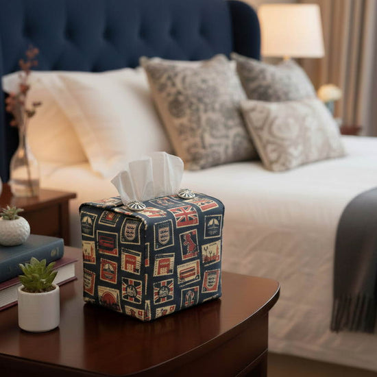 Tissue box cover with British stamps on dark blue design displayed in a bedroom and kitchen