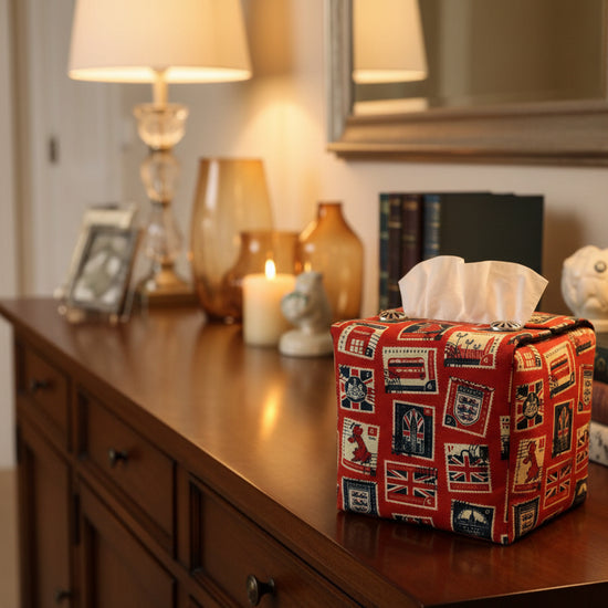 Tissue box cover with British stamps on red design displayed in a bedroom and kitchen