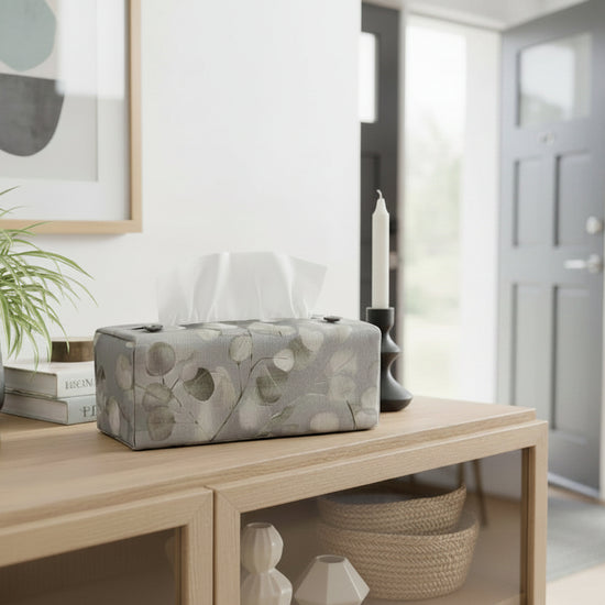 Tissue box cover with lunaria leaves design on grey background displayed in a bathroom and hallway