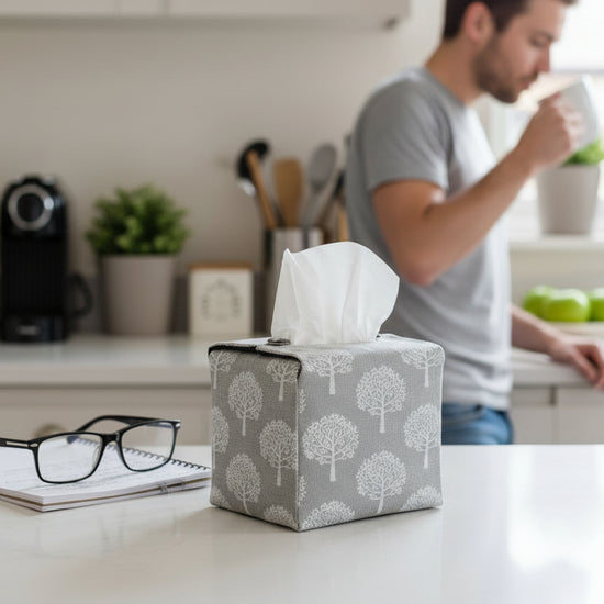 Tissue box cover with white mulberry trees design on taupe background displayed in a kitchen and living room