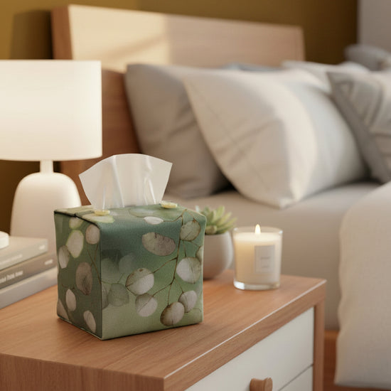 Tissue box cover with lunaria leaves design on green background displayed in a bedroom and living room