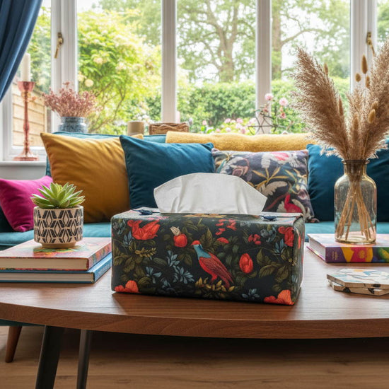 Tissue box cover with colourful birds and floral design displayed in a bathroom and living room