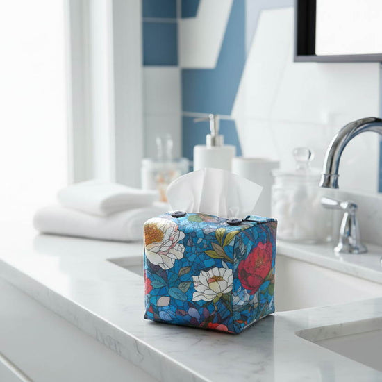 Tissue box cover with floral stained glass design on blue background displayed in a bathroom and bedroom