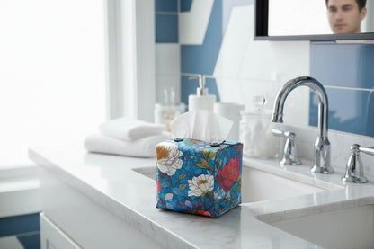 Tissue box cover with floral stained glass design on blue background displayed in a bathroom and bedroom