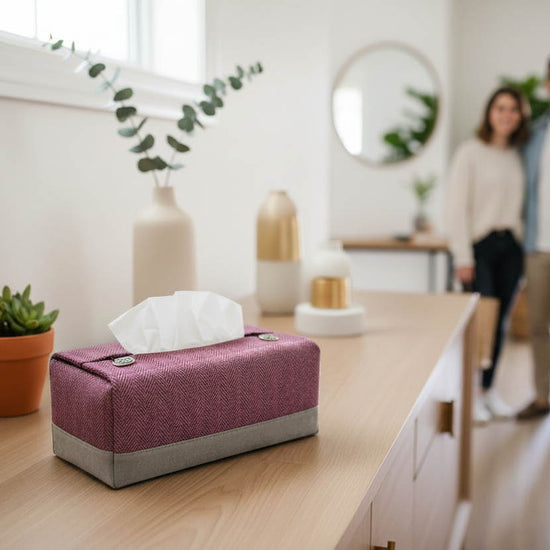Tissue box cover with a two tone mauve herringbone and grey design displayed in a bedroom and hallway