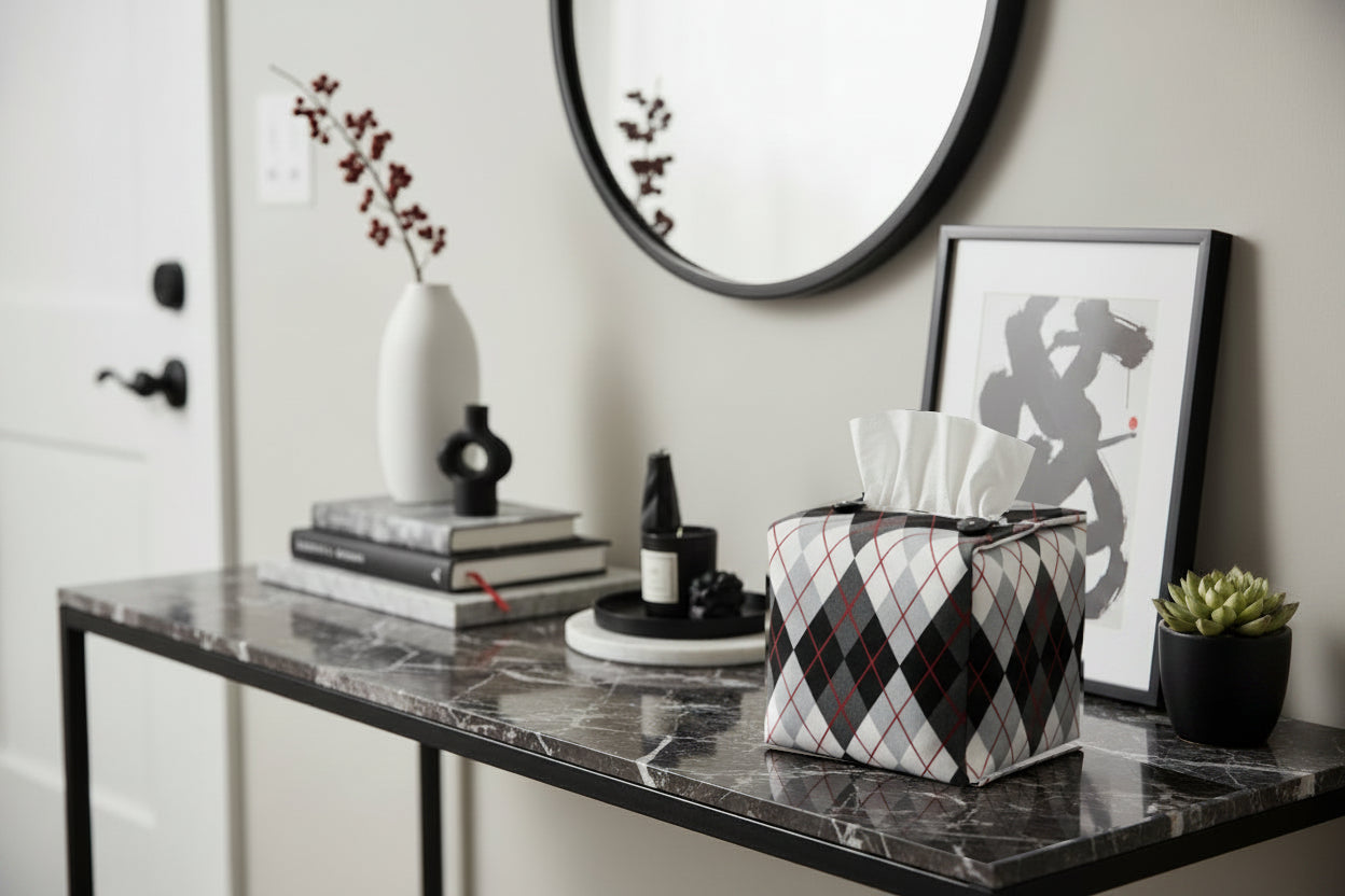 Tissue box cover with black and white Argyle pattern displayed in a home entrance and living room
