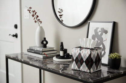 Tissue box cover with black and white Argyle pattern displayed in a home entrance and living room