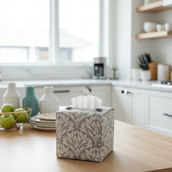 Handmade linen tissue box covers with leaf pattern on grey background displayed in a kitchen and living room