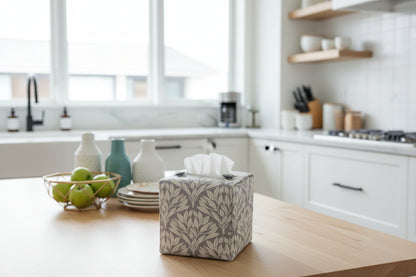 Handmade linen tissue box covers with leaf pattern on grey background displayed in a kitchen and living room