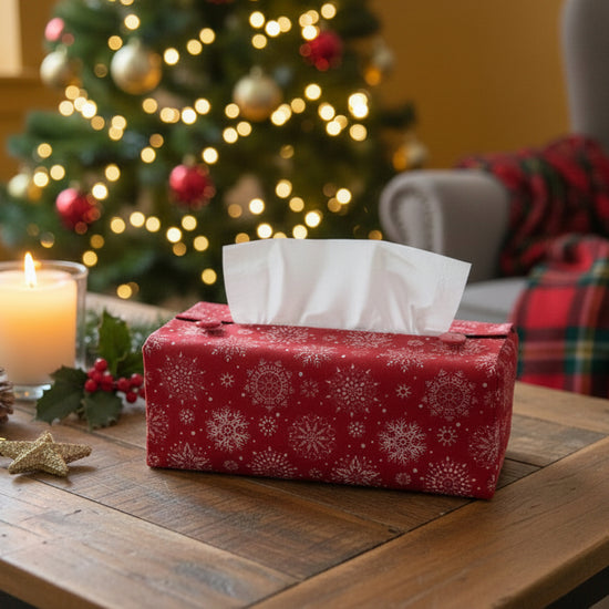 Tissue box cover with white snowflakes on red background design displayed in a hallway and living room