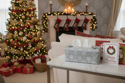 Tissue box cover with white snowflakes on a grey background displayed in a bathroom and living room