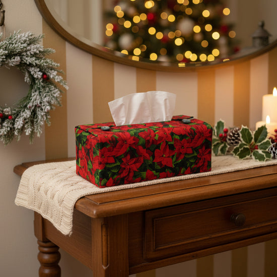 Tissue box cover with a poinsettia design displayed in a hallway