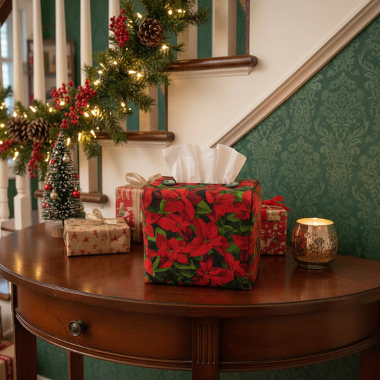 Tissue box cover with a poinsettia design displayed in a hallway