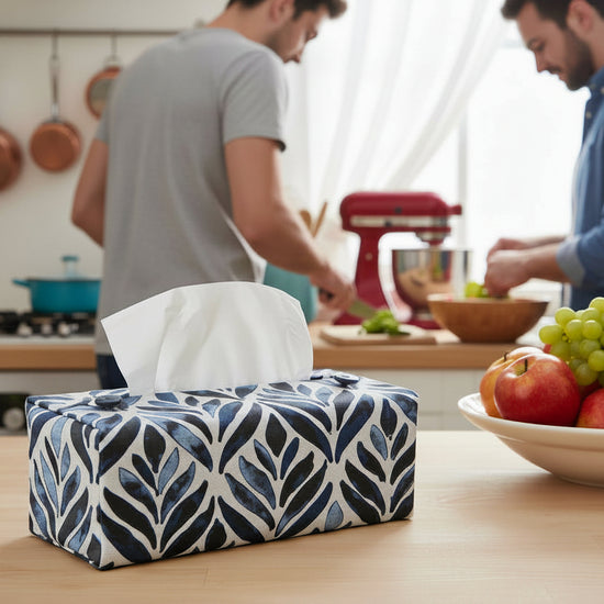 Handmade tissue box covers with navy watercolour leaf design displayed in a bedroom and kitchen